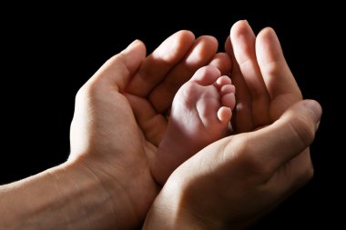 Hands Holding Baby Foot clipart