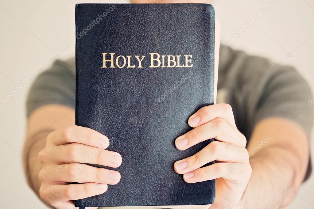 Young Man Proudly Showing Off His Bible Stock Photo By ©Balazs 51538225