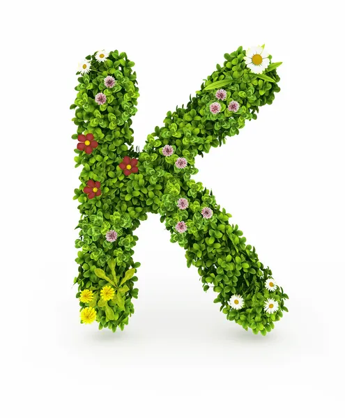 Зеленая грасса буква K — стоковое фото
