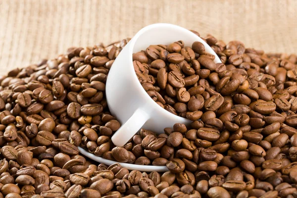 Cup with coffee beans — Stock Photo, Image