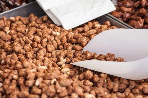 Peanuts glazed with caramel on sale — Stock Photo, Image