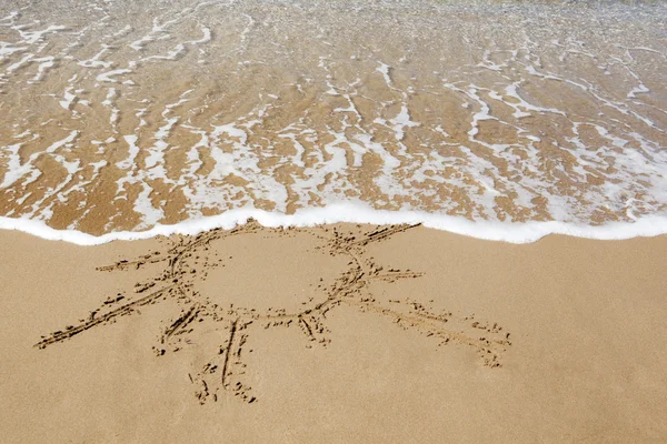 Sun drawn on the sandy beach. — Stock Photo, Image