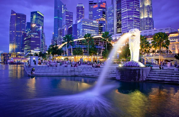 SINGAPORE-DEC 29: The Merlion fountain spouts water in front of the Singapore skyline — Stock Photo, Image