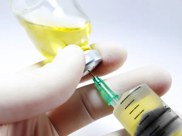 In de hand en in flesje syringe — Stockfoto