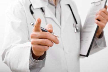 Doctor with cliproard indicating on something with his finger