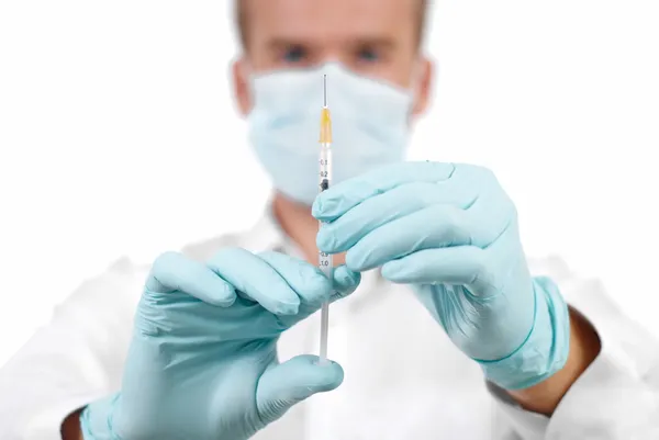 Medical doctor with syringe in hands. — Stock Photo, Image