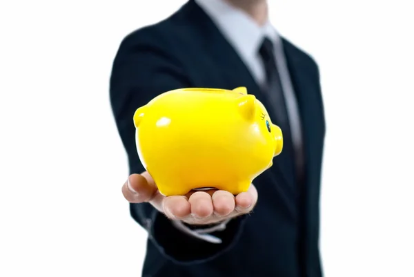 Businessman holding piggy bank in his hand. — Stock Photo, Image