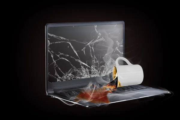 Laptop with cup of hot coffee spilled on the computer — Stock Photo, Image