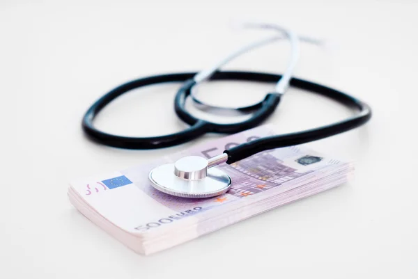 Stethoscope with money  on table — Stock Photo, Image