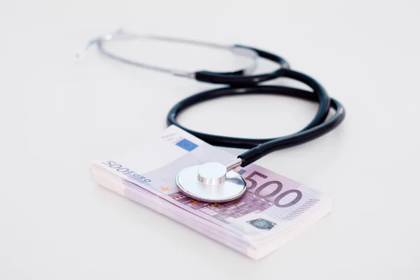 Stethoscope with money  on table — Stock Photo, Image