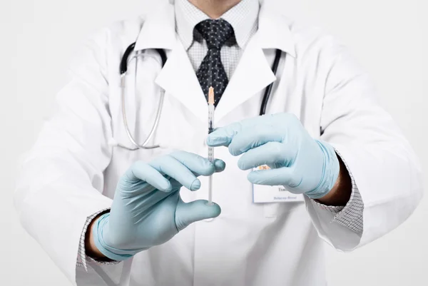 Professional doctor with medical syringe in hands — Stock Photo, Image