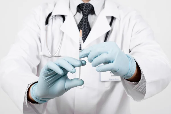 Professional doctor with medical syringe in hands — Stock Photo, Image