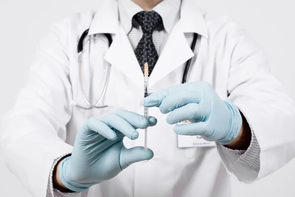 Professional doctor with medical syringe in hands — Stock Photo, Image