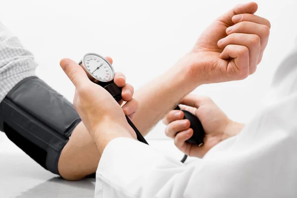 Blood pressure measuring studio shot — Stock Photo, Image