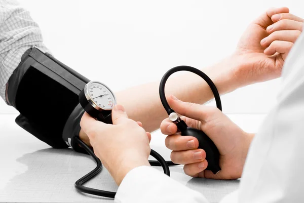 Blood pressure measuring studio shot Stock Photo