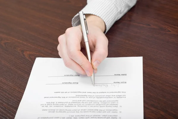 Businessman signs a contract Stock Image