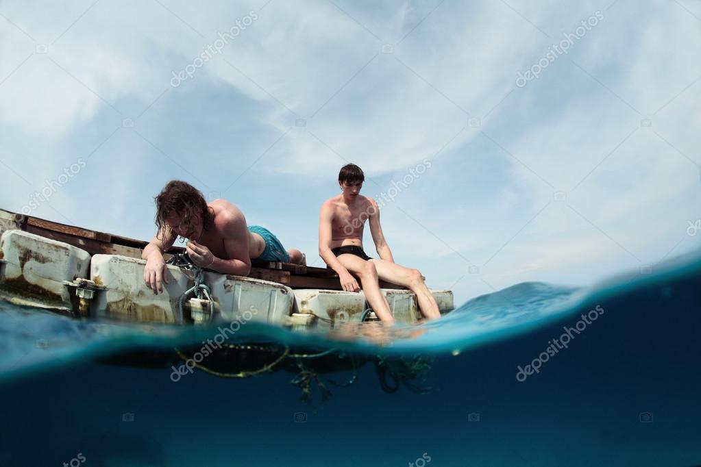 two men were at sea in a small motor two men were at sea in a small motor