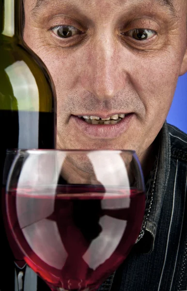 Homem olhando em um copo de vinho — Fotografia de Stock