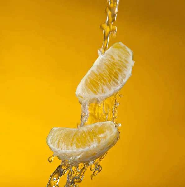 Lóbulos de laranja em água — Fotografia de Stock