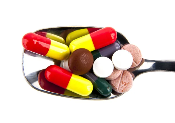 Pills in a spoon — Stock Photo, Image