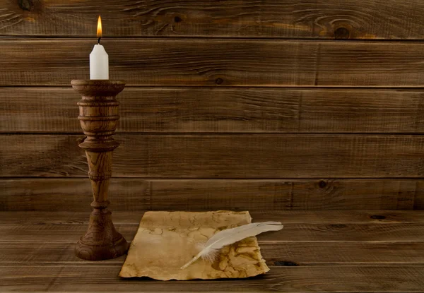 Feather, old paper and candle — Stock Photo, Image