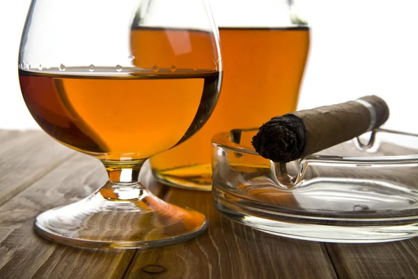 Glass and bottle of cognac with cigar — Stock Photo, Image