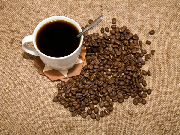 Cup of coffee and grain — Stock Photo, Image