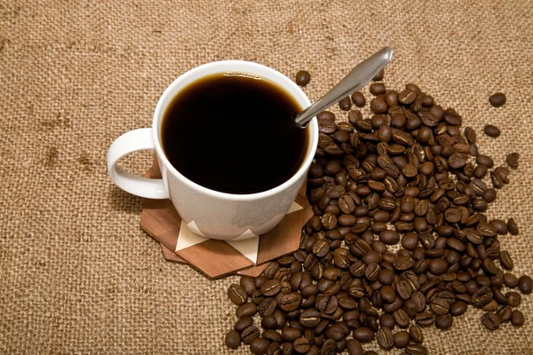 Cup of coffee and grain — Stock Photo, Image