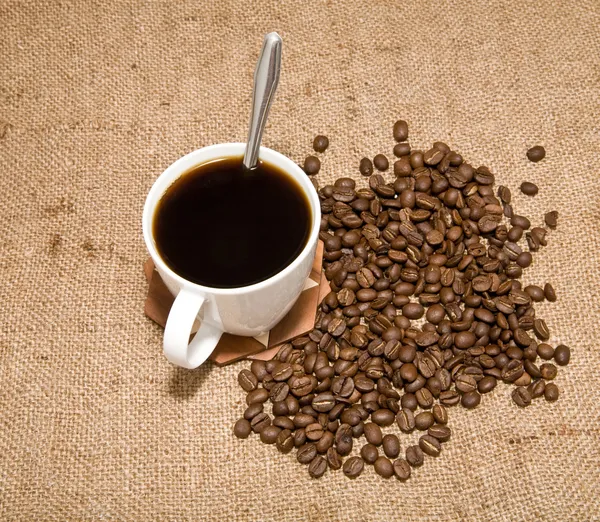 Cup of coffee and grain — Stock Photo, Image