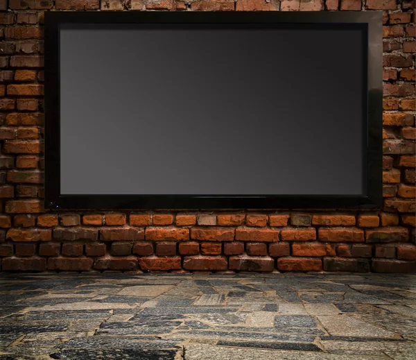 Television set on an old wall — Stock Photo, Image