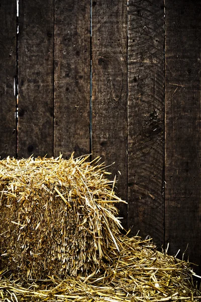 Bale of straw and wooden background — Stock Photo, Image