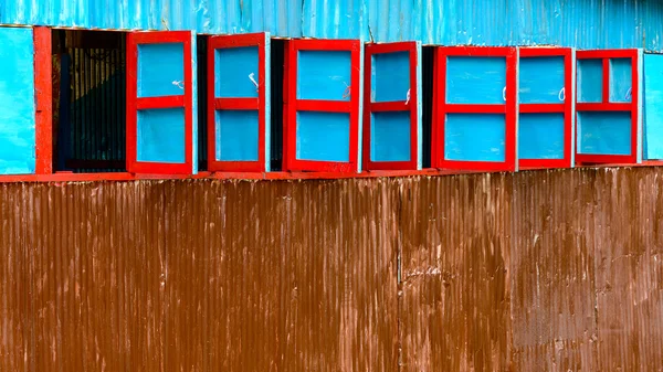 Czerwone i niebieskie okna drewniane — Zdjęcie stockowe