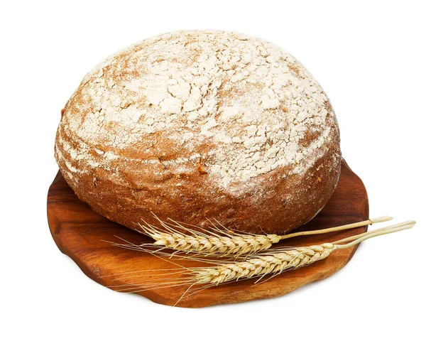 Traditional rye bread and wheat on a wooden board — Stock Photo, Image