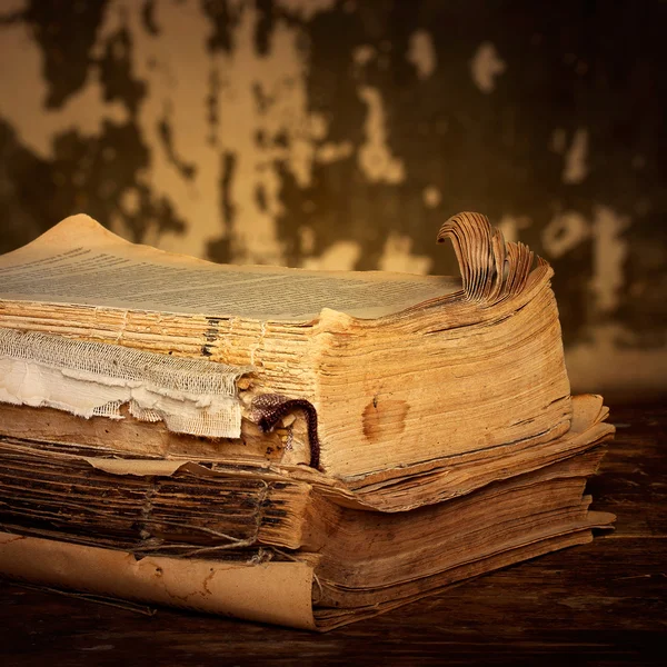 Dilapidated books on a wooden surface, sepia — Stock Photo, Image