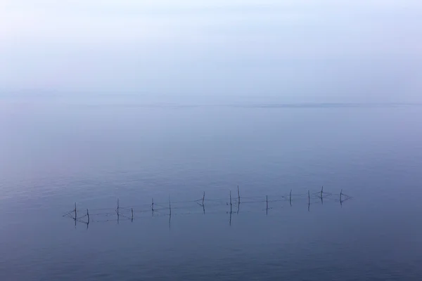 Minimalism . Seascape networks fishermen with the horizon line d