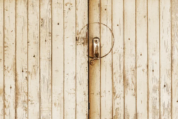 Old wooden door with metal handle and lock — Stock Photo, Image