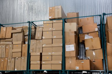Clutter stock cardboard packing boxes in the factory clipart