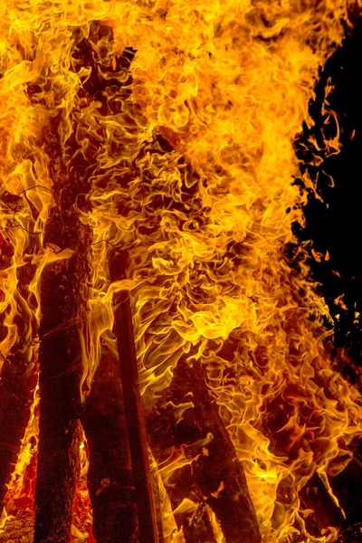 Fogata ardiente por la noche, peina la llama como textura y fondo — Foto de Stock