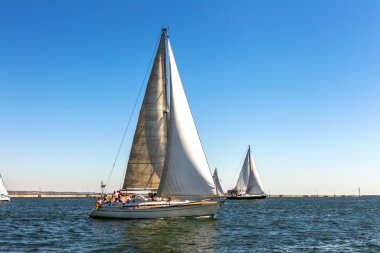 Odessa, Ukraine - May 28, 2011: Sailing yacht out in the coastal clipart