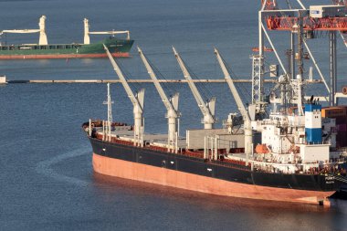 ODESSA, UKRAINE-NOVEMBER 27, 2021: Odessa commercial sea port in peacetime 4 months before start of war with Russia. Marine cranes, warehouses, tankers, cargo, containers and ships in  seaport harbor