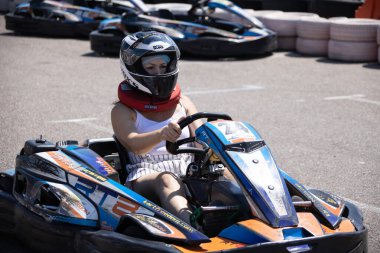 ODESSA, UKRAINE - August 7, 2022: Healthy lifestyle. Sport family. Family vacation at karting track. Children with parents go in for motorsports. Karting. Hobbies, sports education, leisure, lifestyle