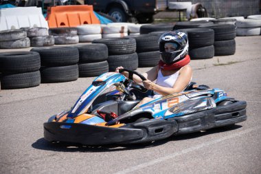 ODESSA, UKRAINE - August 7, 2022: Healthy lifestyle. Sport family. Family vacation at karting track. Children with parents go in for motorsports. Karting. Hobbies, sports education, leisure, lifestyle