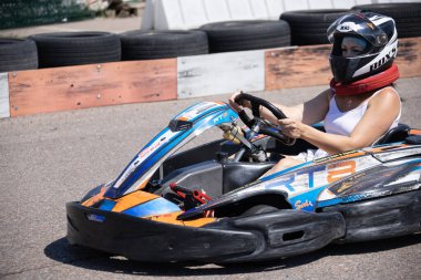 ODESSA, UKRAINE - August 7, 2022: Healthy lifestyle. Sport family. Family vacation at karting track. Children with parents go in for motorsports. Karting. Hobbies, sports education, leisure, lifestyle