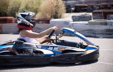 ODESSA, UKRAINE - August 7, 2022: Healthy lifestyle. Sport family. Family vacation at karting track. Children with parents go in for motorsports. Karting. Hobbies, sports education, leisure, lifestyle