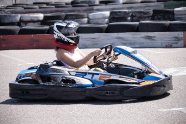 ODESSA, UKRAINE - August 7, 2022: Healthy lifestyle. Sport family. Family vacation at karting track. Children with parents go in for motorsports. Karting. Hobbies, sports education, leisure, lifestyle