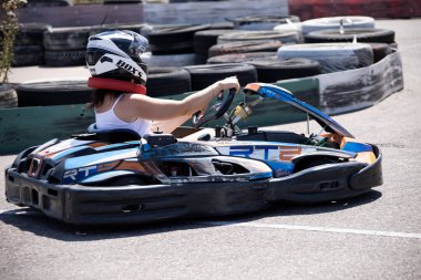 ODESSA, UKRAINE - August 7, 2022: Healthy lifestyle. Sport family. Family vacation at karting track. Children with parents go in for motorsports. Karting. Hobbies, sports education, leisure, lifestyle