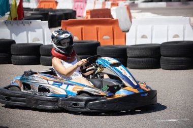 ODESSA, UKRAINE - August 7, 2022: Healthy lifestyle. Sport family. Family vacation at karting track. Children with parents go in for motorsports. Karting. Hobbies, sports education, leisure, lifestyle