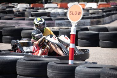 ODESSA, UKRAINE - August 7, 2022: Healthy lifestyle. Sport family. Family vacation at karting track. Children with parents go in for motorsports. Karting. Hobbies, sports education, leisure, lifestyle