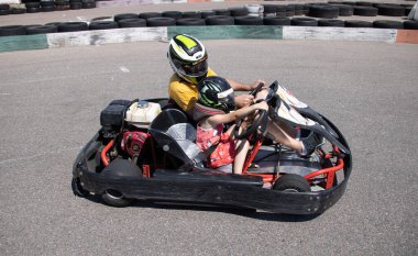 ODESSA, UKRAINE - August 7, 2022: Healthy lifestyle. Sport family. Family vacation at karting track. Children with parents go in for motorsports. Karting. Hobbies, sports education, leisure, lifestyle