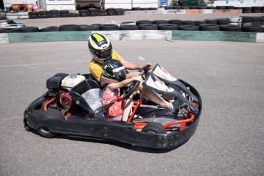 ODESSA, UKRAINE - August 7, 2022: Healthy lifestyle. Sport family. Family vacation at karting track. Children with parents go in for motorsports. Karting. Hobbies, sports education, leisure, lifestyle
